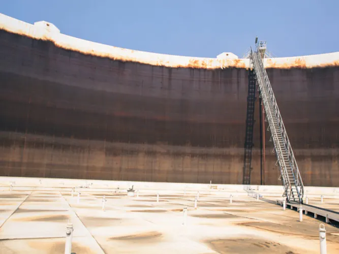 Engineer inspecting a refurbished industrial tank Quality inspection of refurbished tank Astha Tank Construction